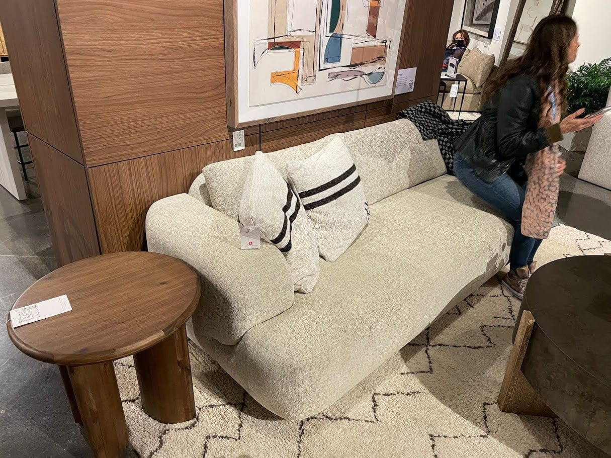 Gray sofa with decorative pillows in a showroom setting