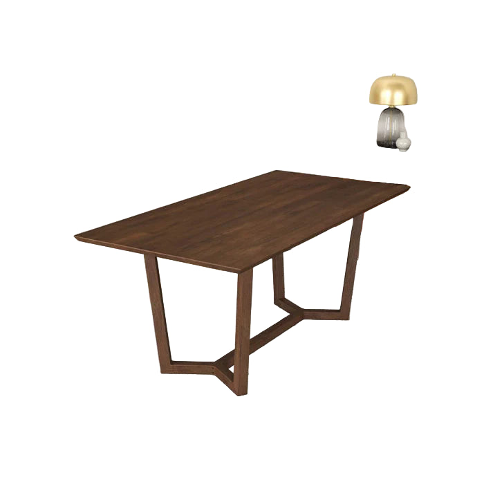 Wooden dining table in a modern living room setting with a dresser and lamp in the background.