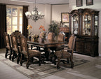 Dining room with wooden table and chairs, large china cabinet, and decorative elements.