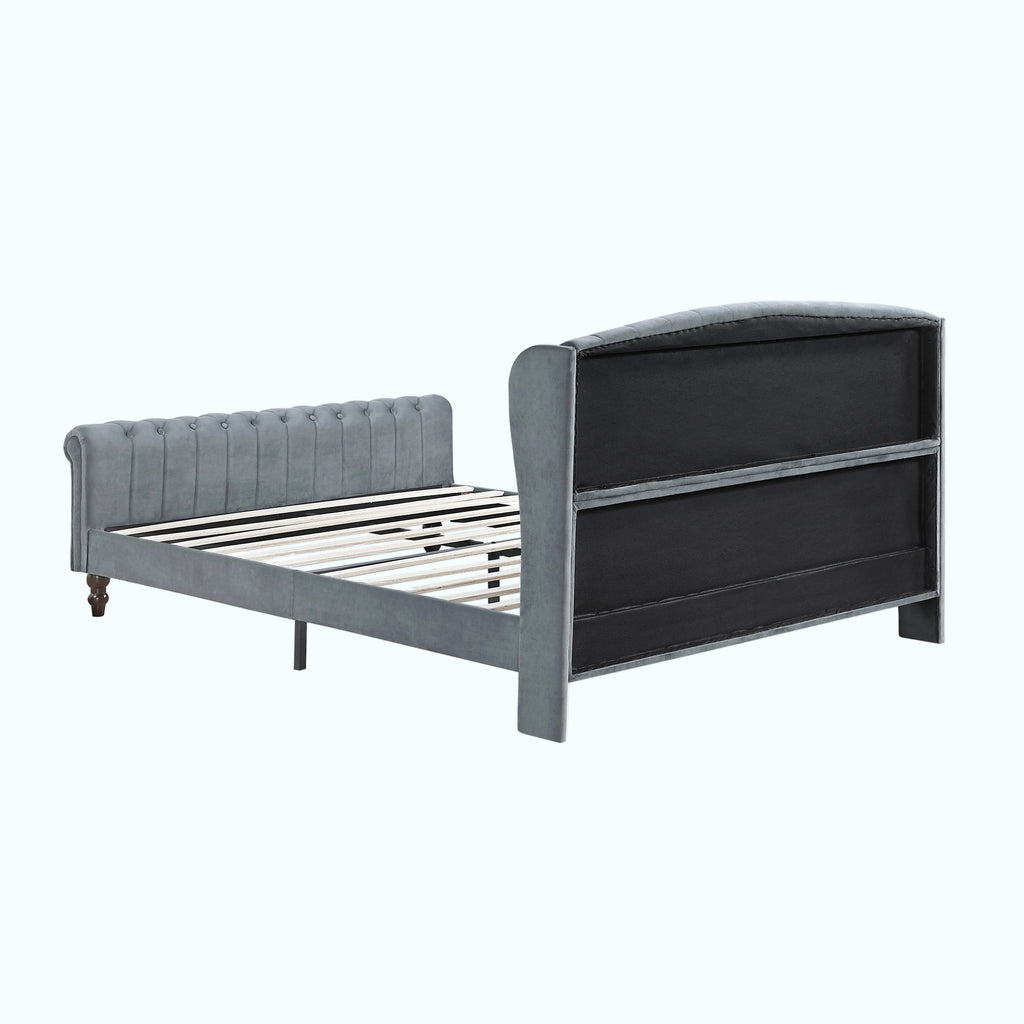 A gray upholstered bed frame with a tufted headboard and a tall, curved backboard with horizontal panel lines, shown on a plain white background.