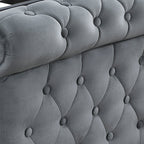 A close-up of a gray tufted velvet bed frame with wooden slats and turned black legs, shown on a white background.