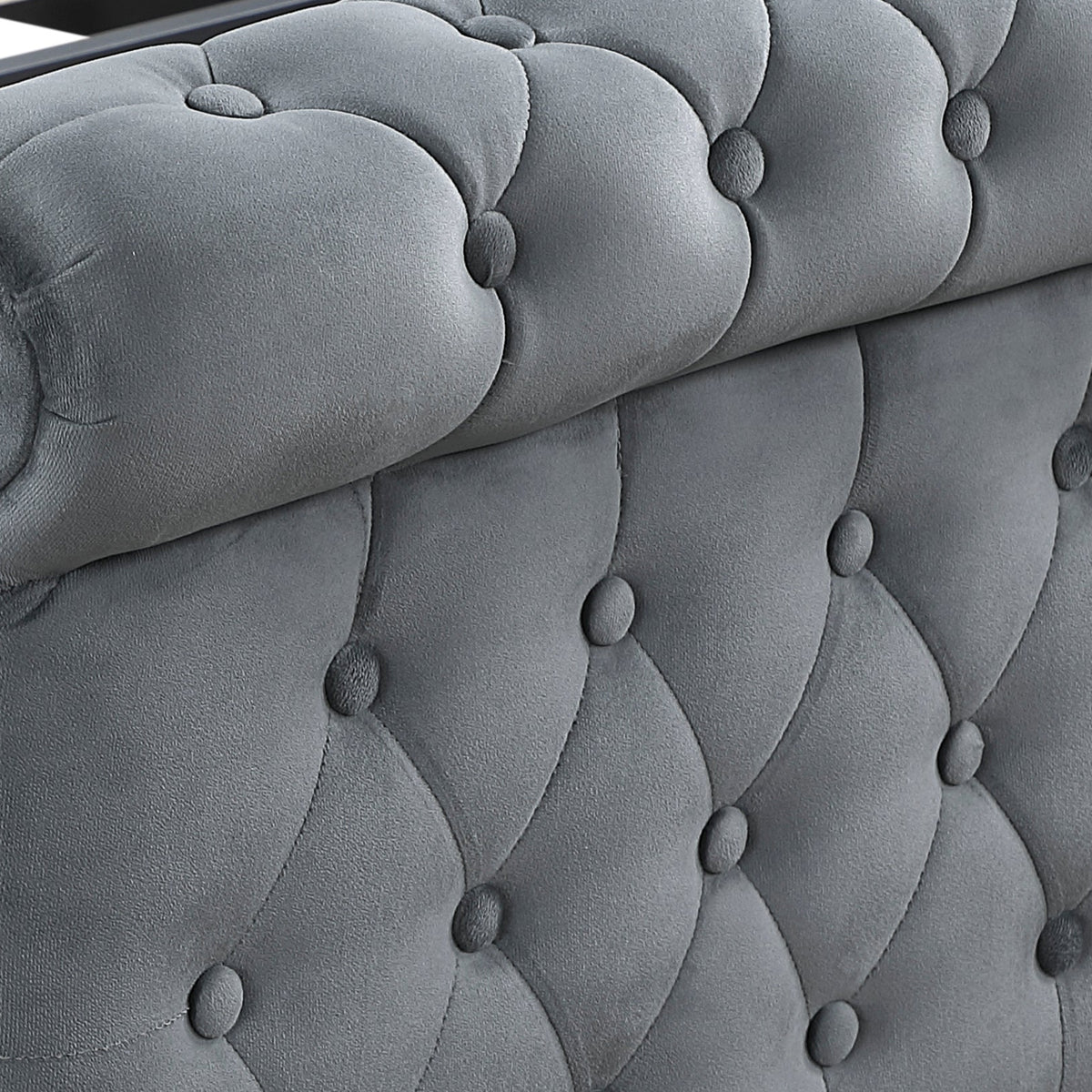 A close-up of a gray tufted velvet bed frame with wooden slats and turned black legs, shown on a white background.