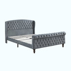 A gray tufted velvet bed frame with a wingback headboard and matching footboard, shown on a white background.
