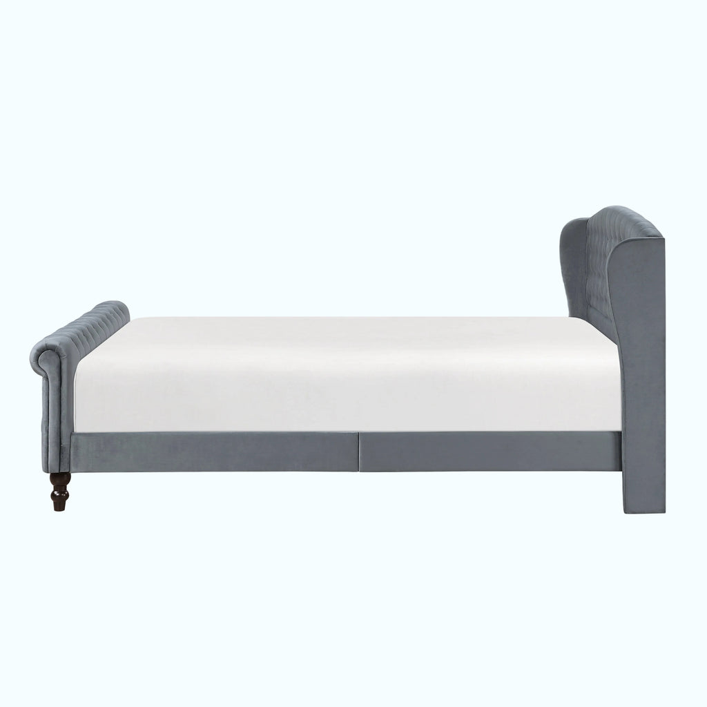 A gray upholstered bed frame with a white mattress, shown from a side profile view against a plain white background.