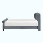 A gray upholstered bed frame with a white mattress, shown from a side profile view against a plain white background.