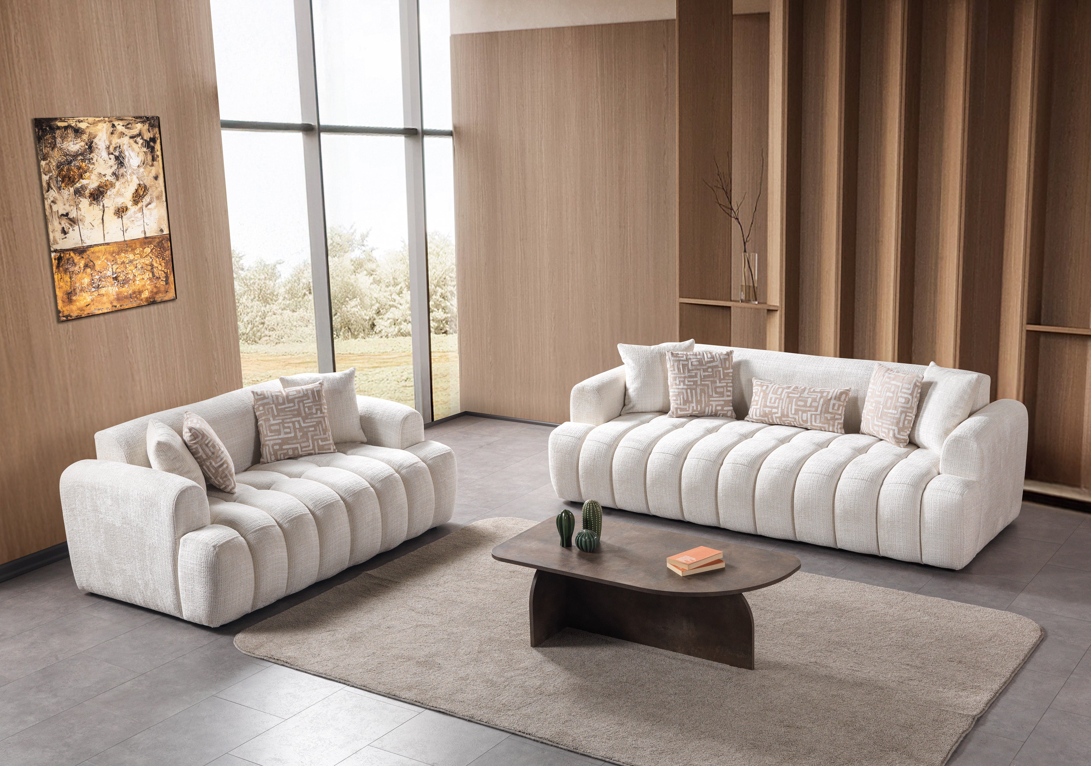 Modern living room with white sofas, a coffee table, and decorative elements.
