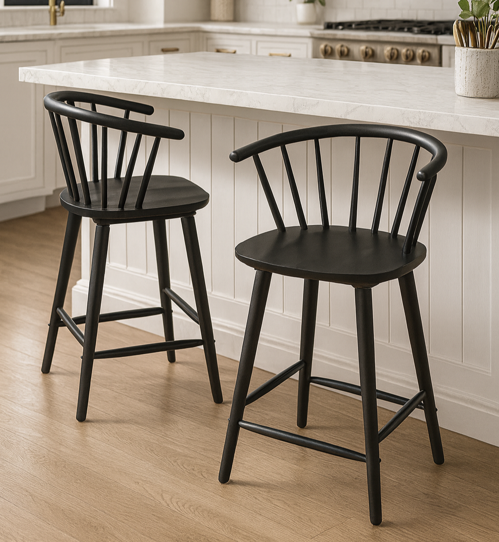 Two black bar stools in a kitchen with white countertops and cabinets.