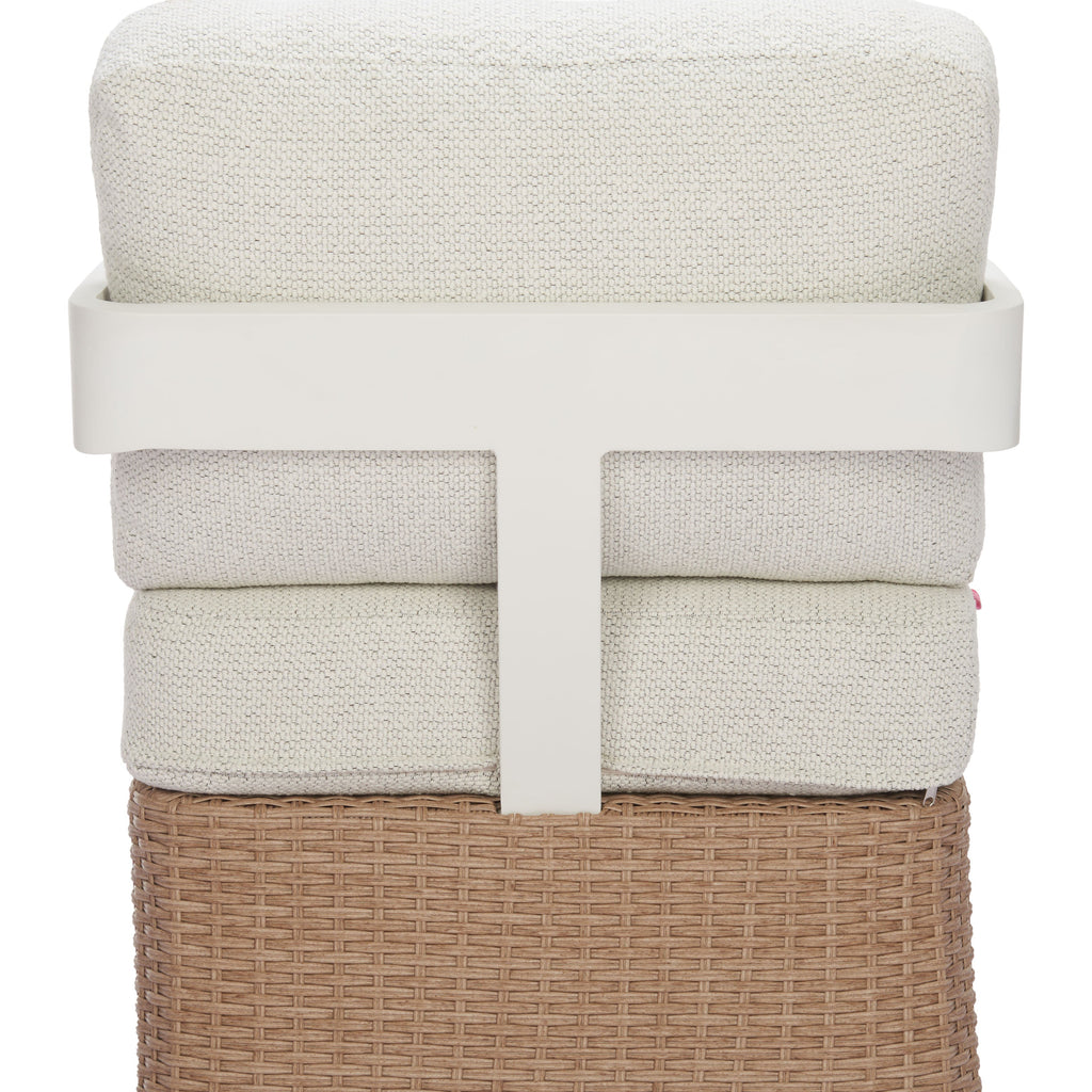 Stack of beige towels in a woven basket on a white background