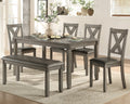 Dining room set with gray table and chairs in a home setting.