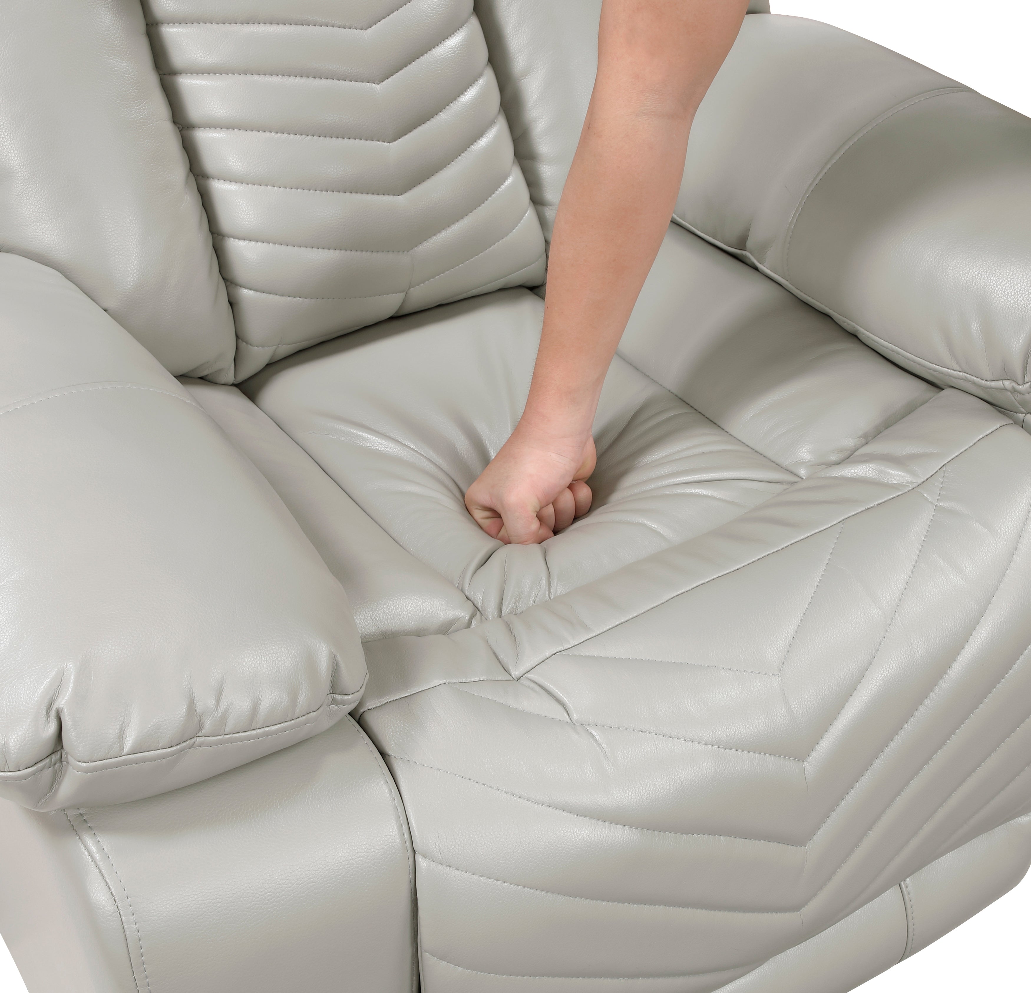 Light gray recliner chair with a person's foot on the seat