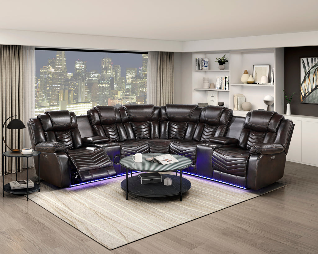 Modern living room with a large brown leather sectional sofa, coffee table, and cityscape view.