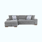 Gray sectional sofa with patterned cushions on a white background