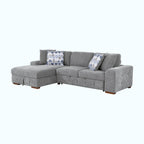 Gray sectional sofa with patterned cushions on a white background