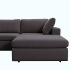 Gray sectional sofa with a pillow on a white background
