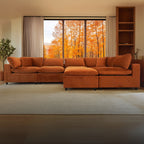 Orange sectional sofa in a living room with a window view of autumn trees.