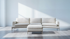 Modern beige sectional sofa in a minimalistic room with light gray floor and white walls.