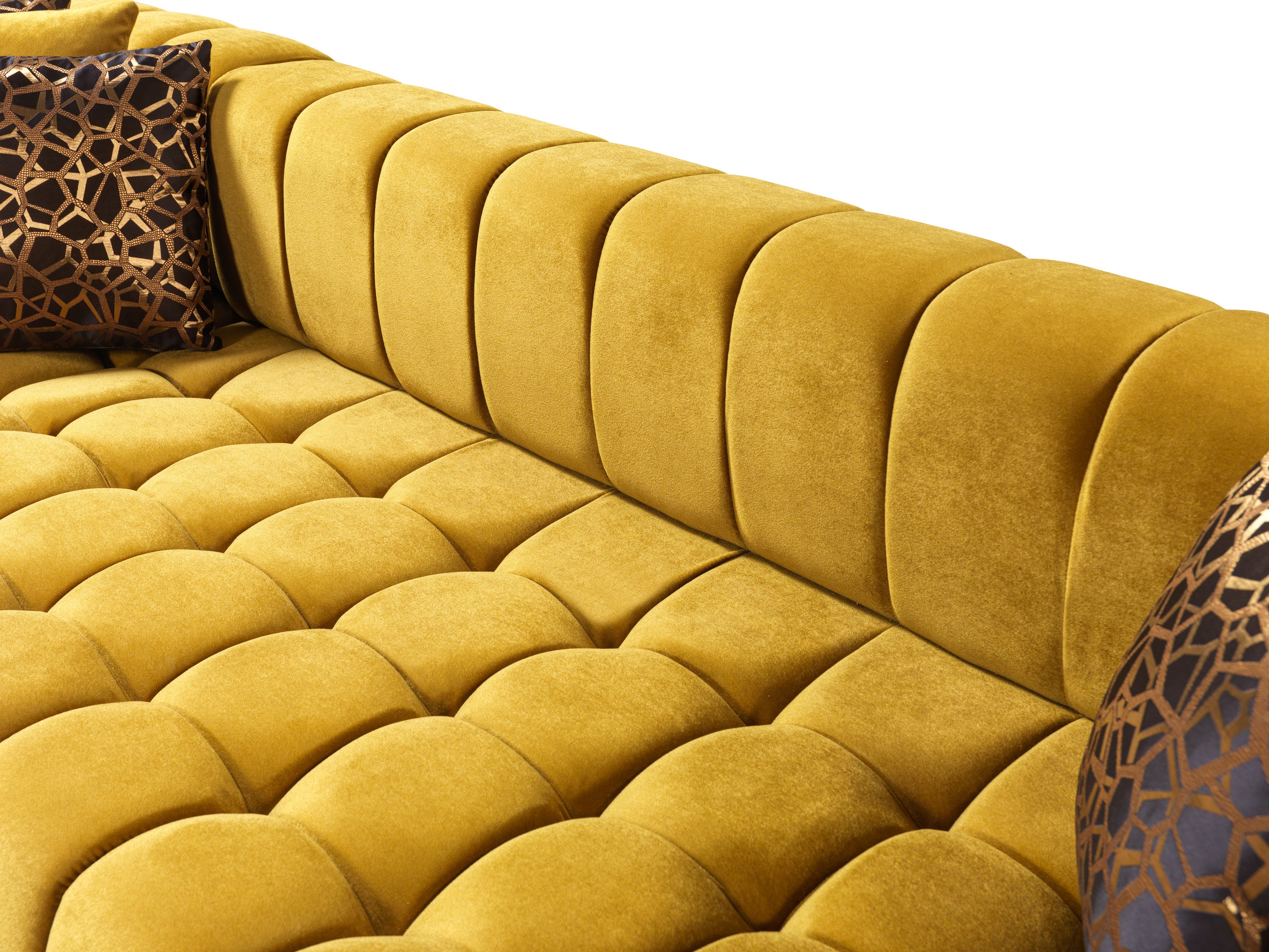 Yellow tufted sofa with decorative pillows on a white background