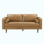 A two-seater loveseat sofa upholstered in tan leather, featuring cylindrical armrests and tapered wooden legs, shown against a plain white background.