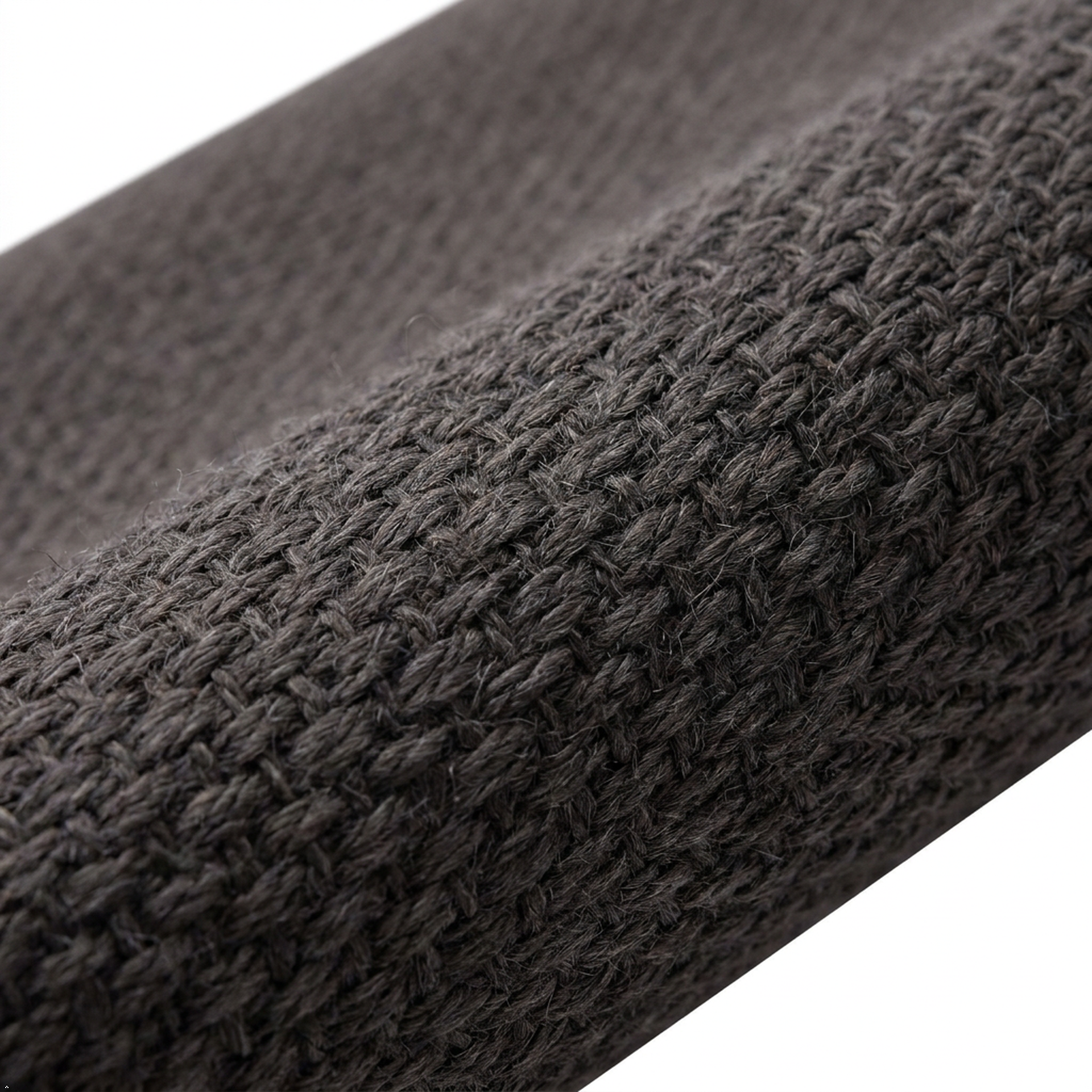 Close-up of a textured dark gray fabric roll