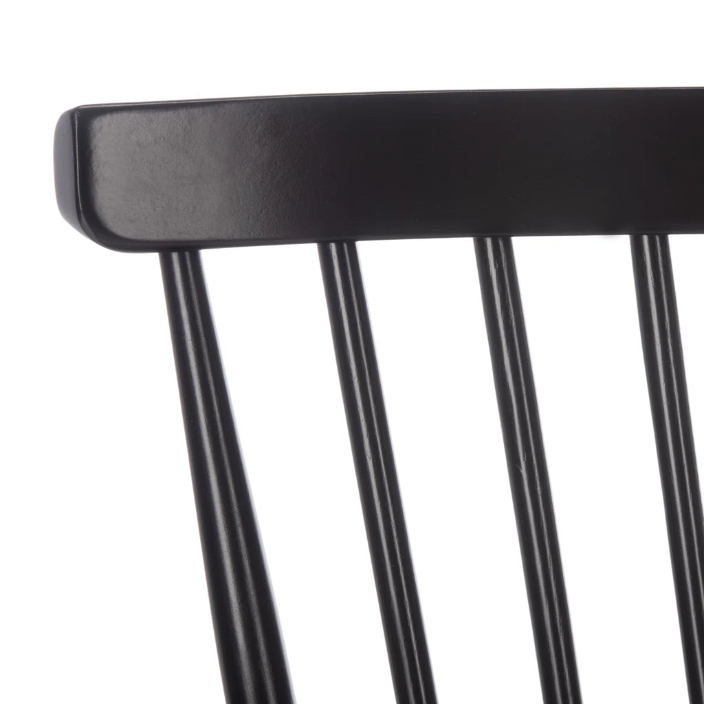 Close-up of a black chair backrest on a white background