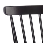 Close-up of a black chair backrest on a white background