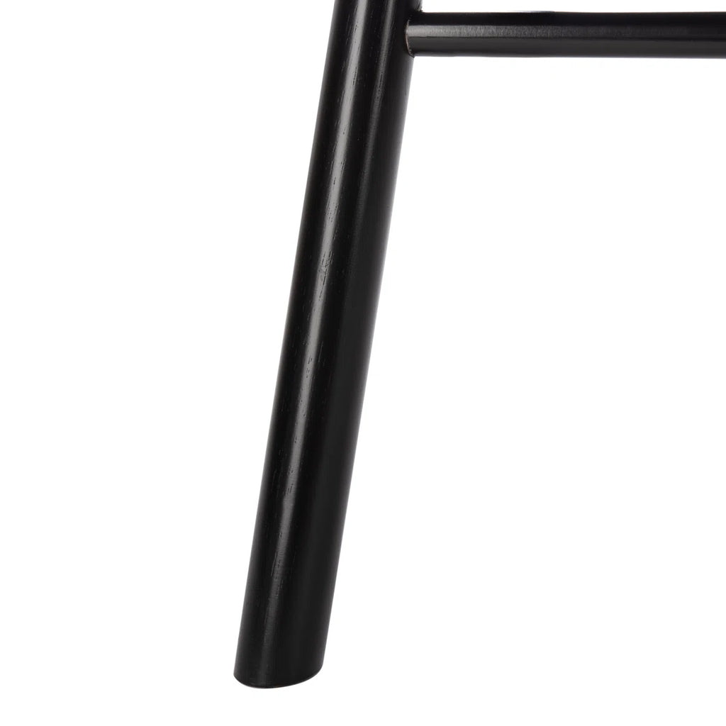 Close-up of a black metal chair leg on a white background