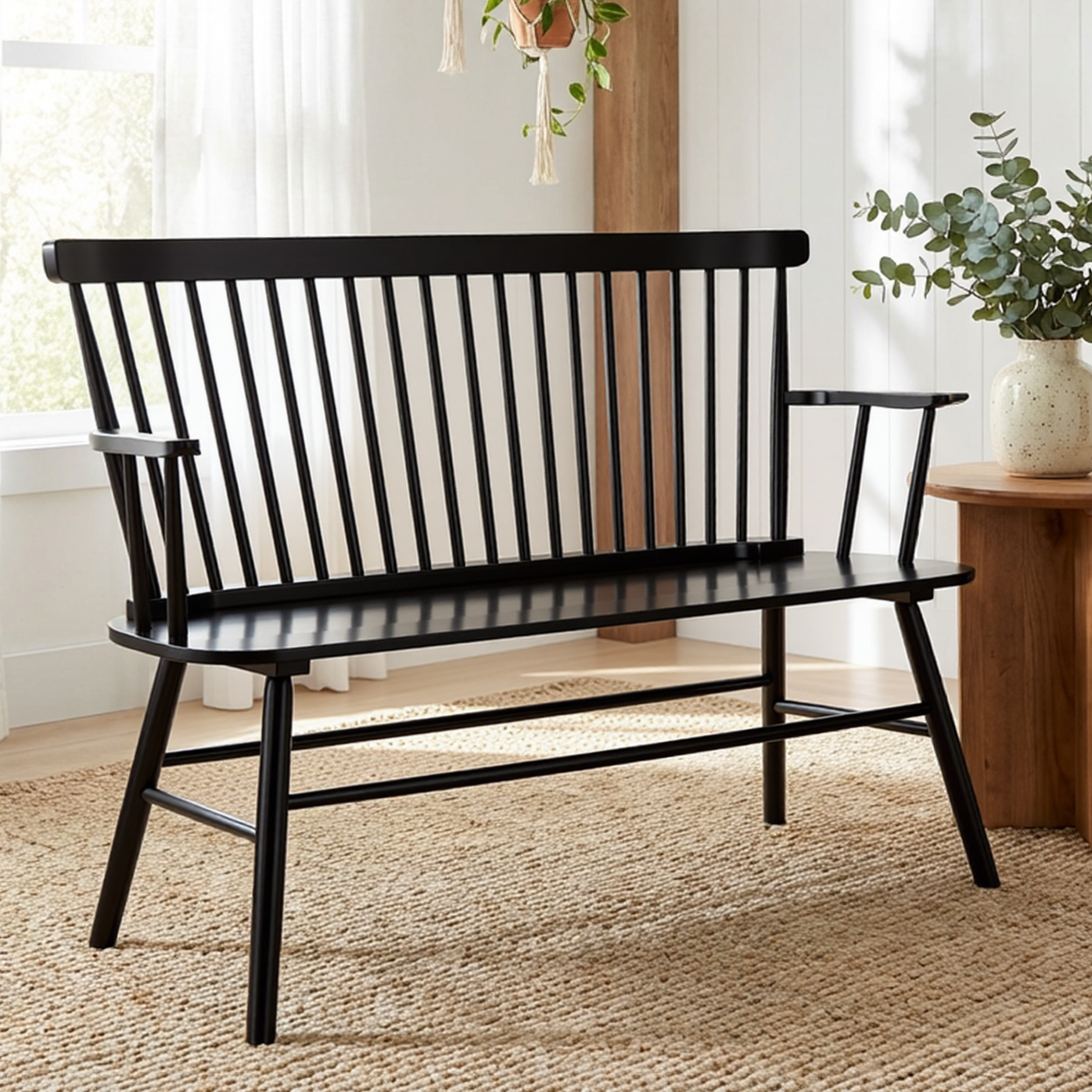 Black metal bench in a room with plants and a wooden side table.