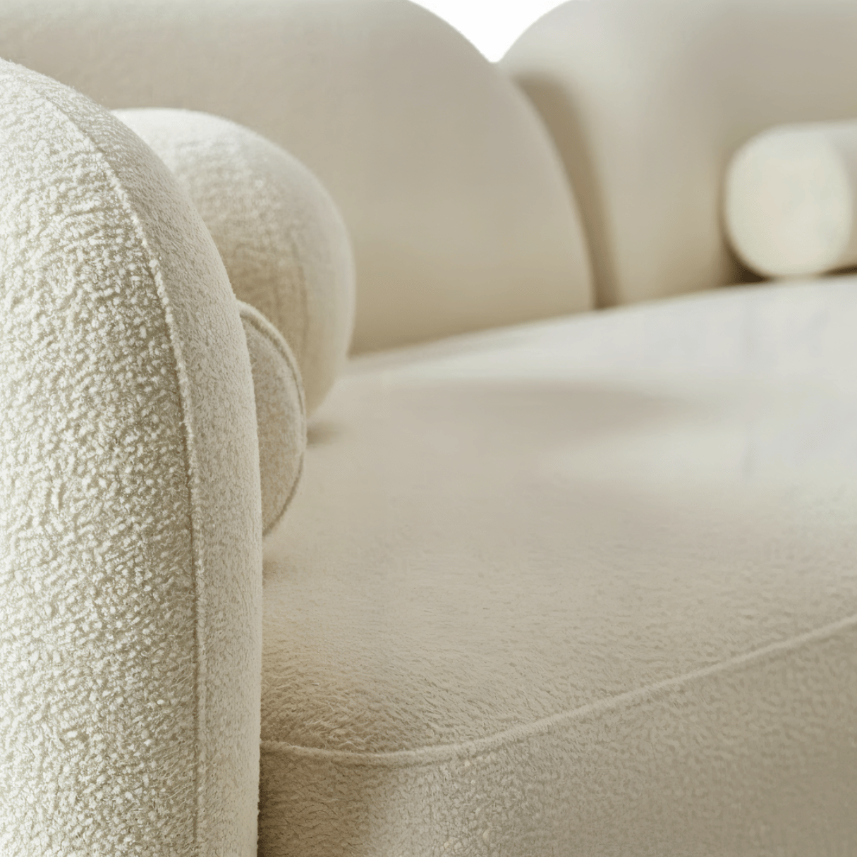 Close-up of a beige textured sofa with a blurred background