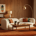 Modern living room with a white sofa, wooden coffee table, and decorative elements.