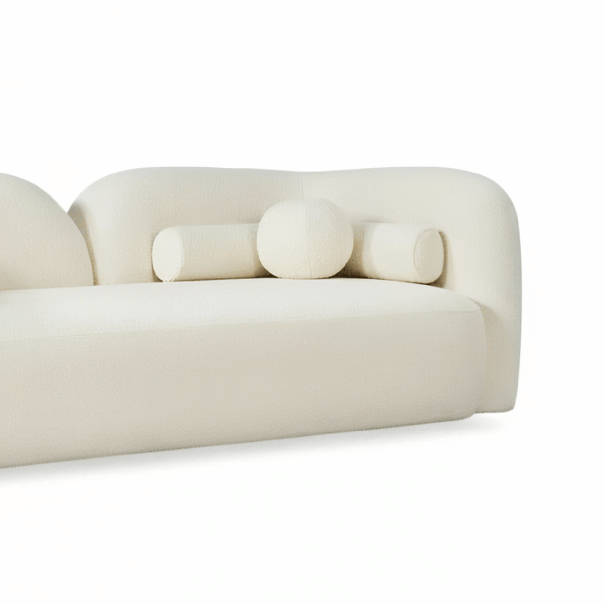 Modern cream-colored sofa with cylindrical design elements on a white background