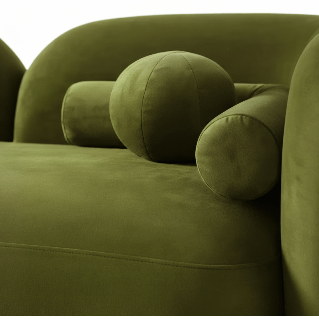 Close-up of a green sofa with rounded cushions on a white background