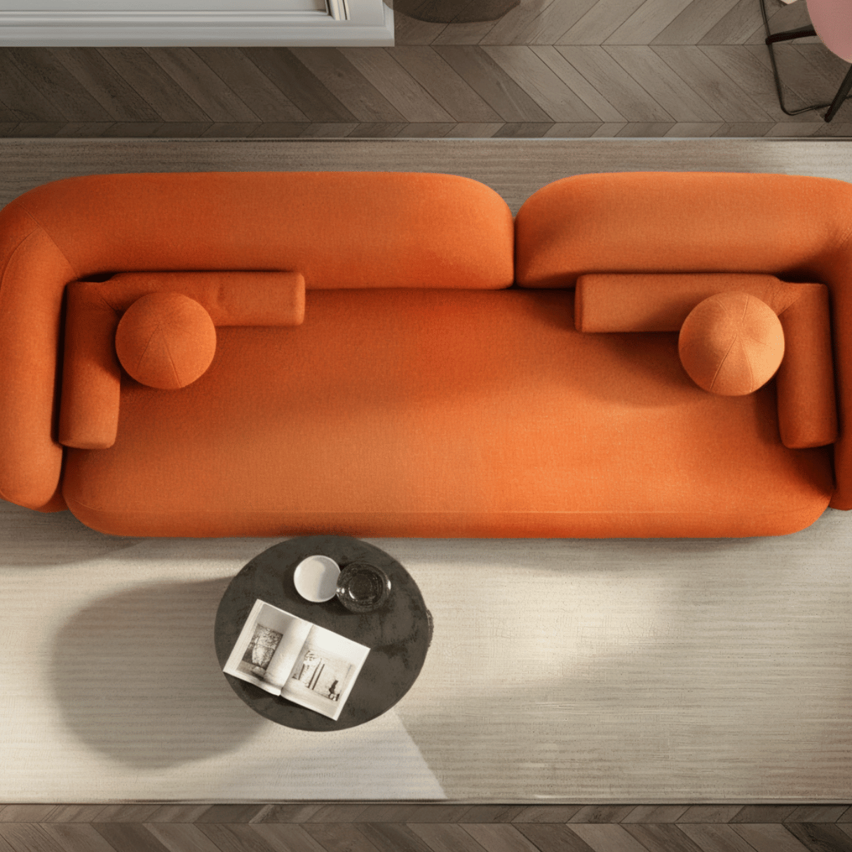 Orange sofa in a modern living room with a coffee table and decor items.