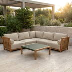 Beige outdoor sectional sofa with wooden armrests and a green coffee table on a patio.