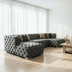 Gray tufted sectional sofa in a modern living room with large windows.