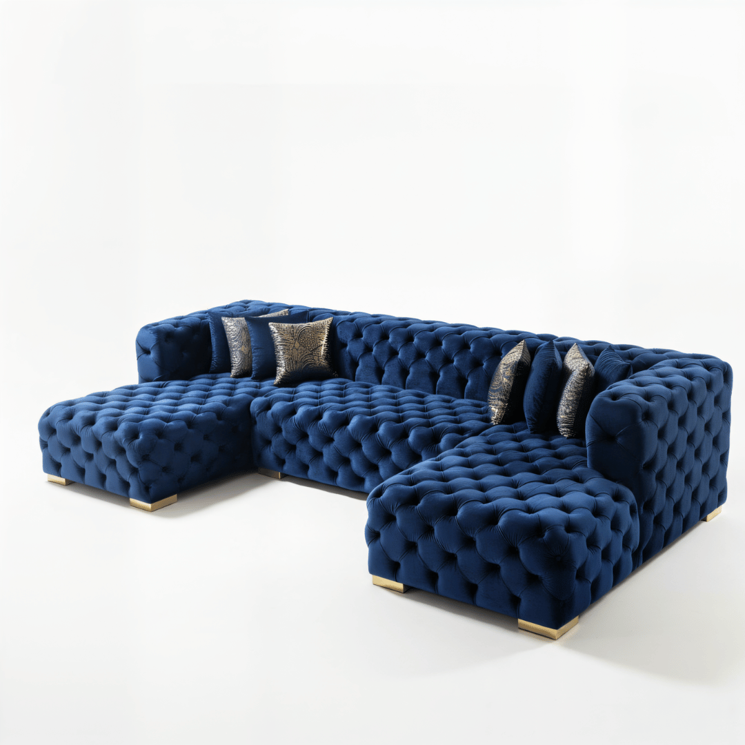 Blue tufted sectional sofa with gold legs on a white background