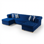 Blue tufted sectional sofa with decorative pillows on a white background