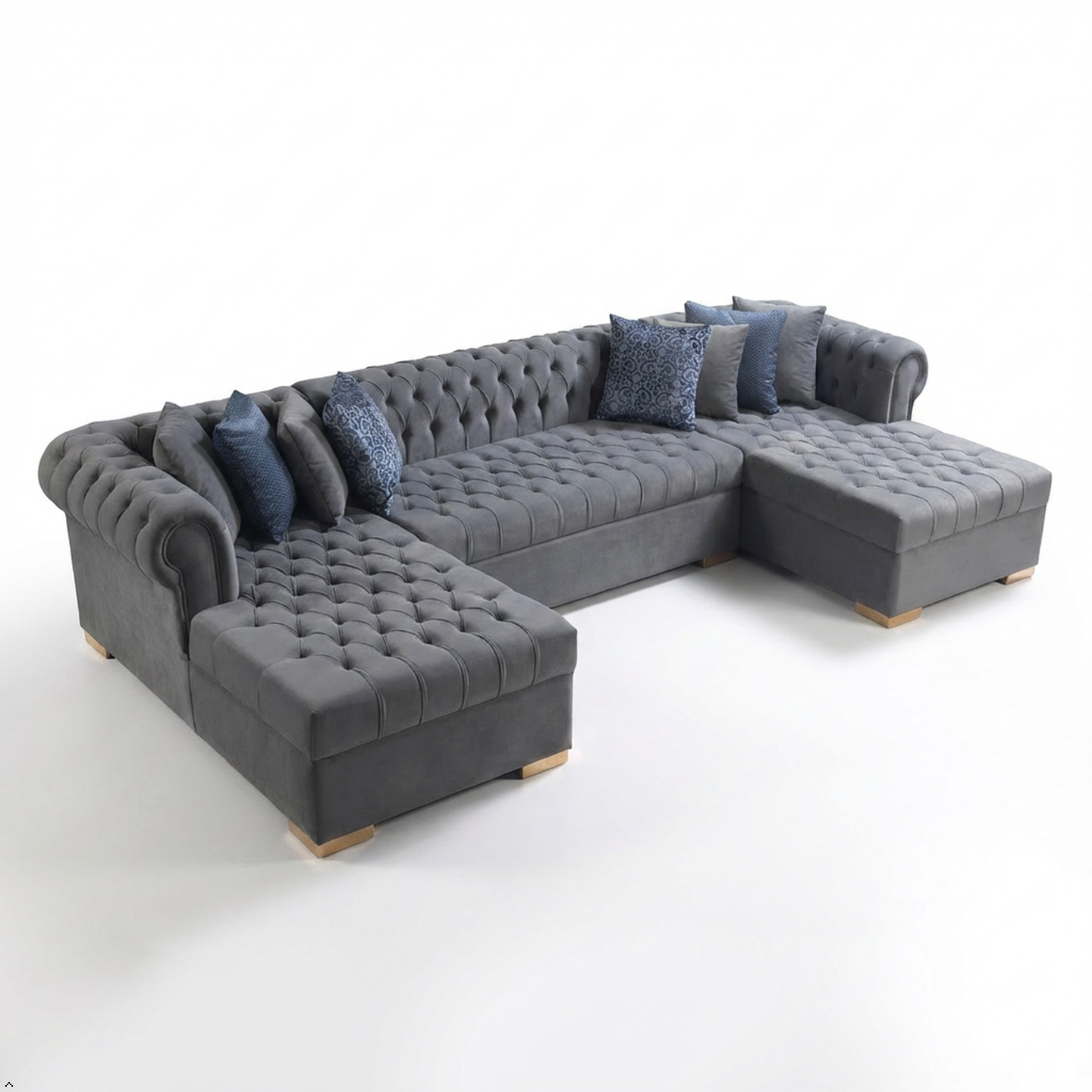 Gray sectional sofa with tufted cushions on a white background