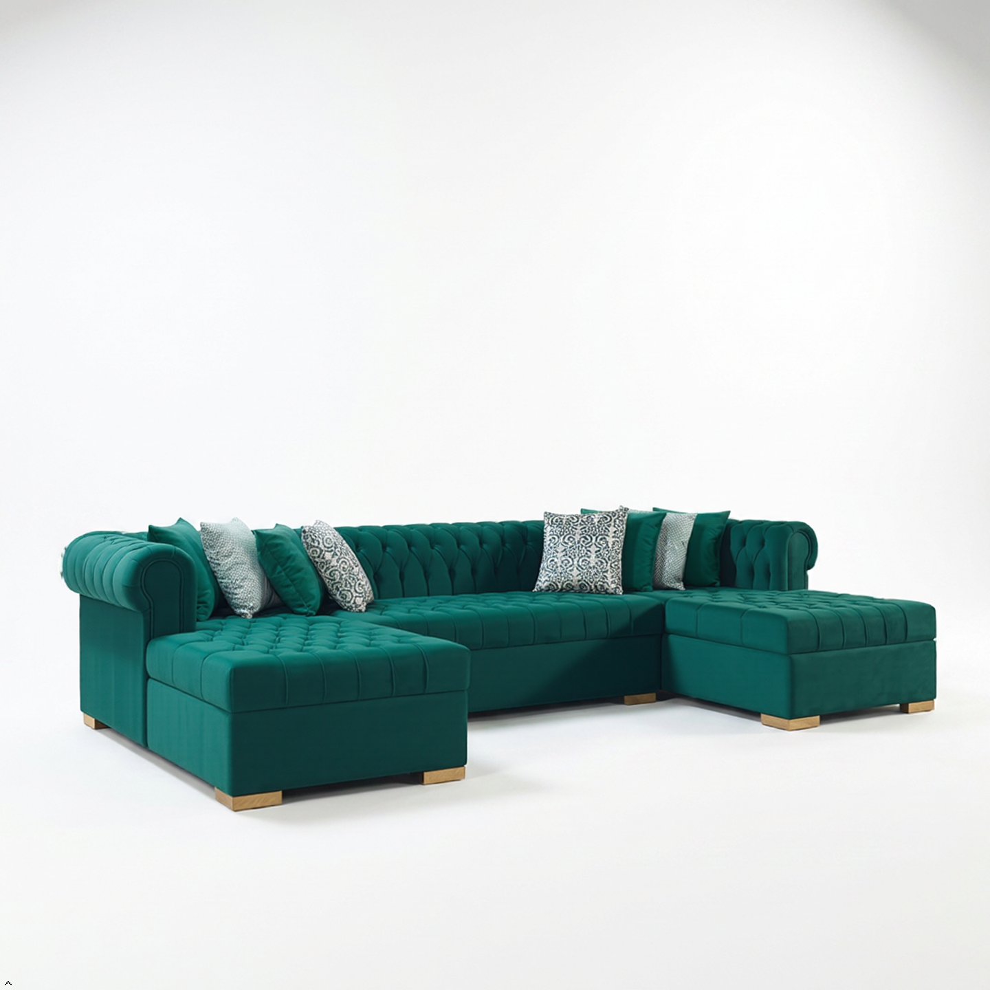 Green sectional sofa with decorative pillows on a white background