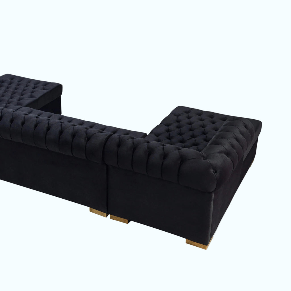 Black tufted sofa on a white background