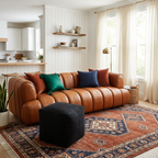 Brown leather sofa with colorful pillows in a living room setting.