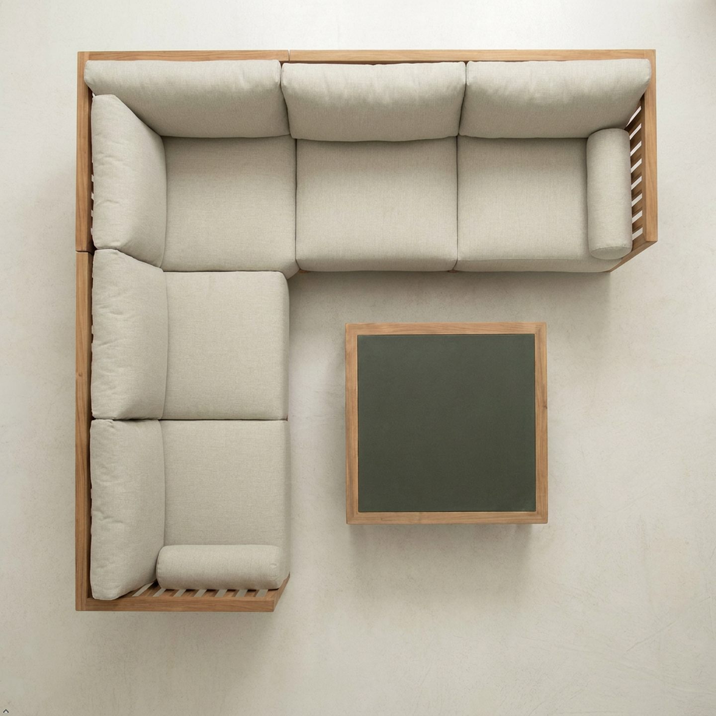 Beige sectional sofa with wooden frame and small table on a white background