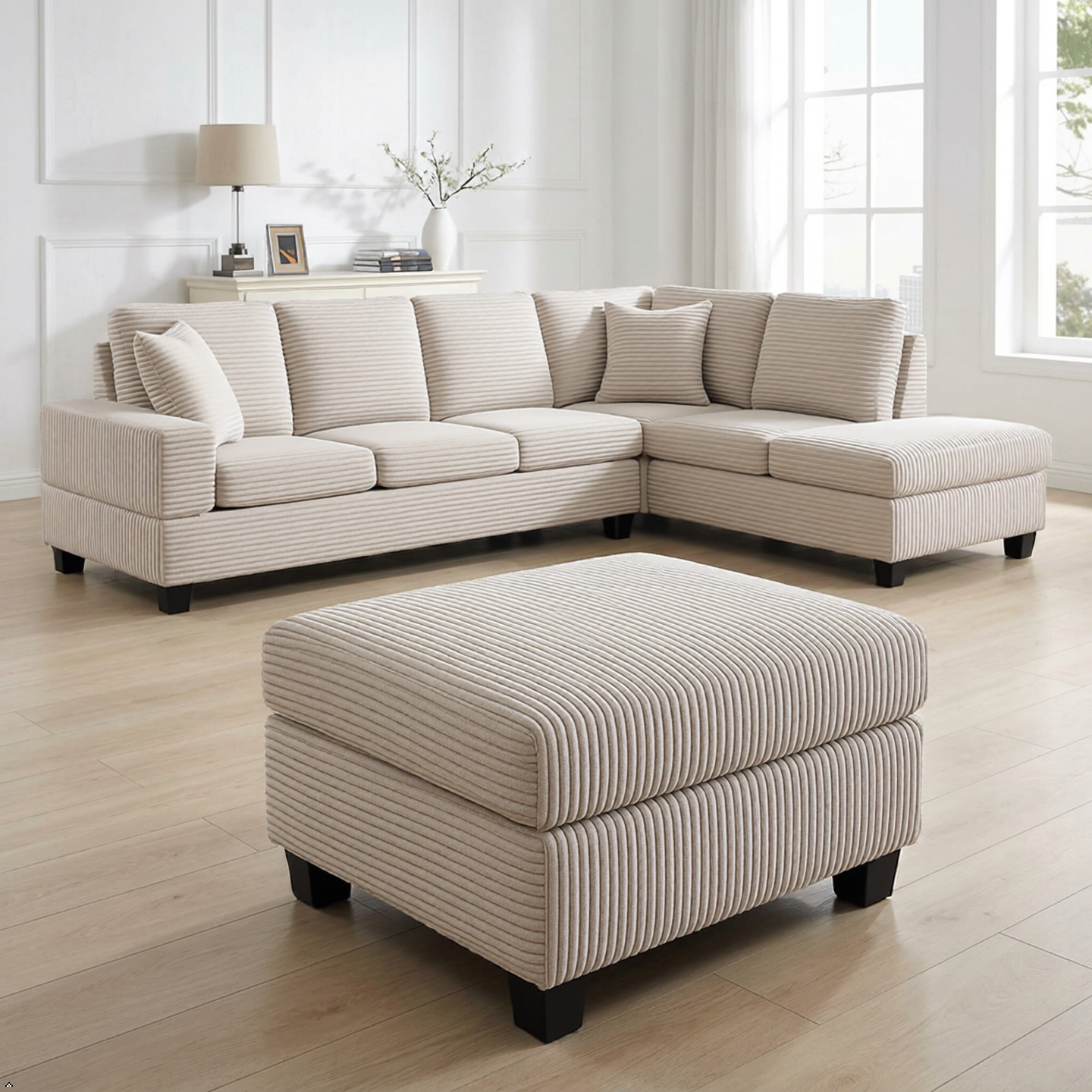Beige sectional sofa with matching ottoman in a bright living room.