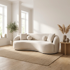 Beige sofa in a bright living room with large windows and decorative plants.