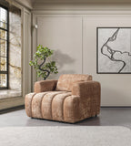 Brown armchair in a modern living room with a plant and abstract art on the wall.
