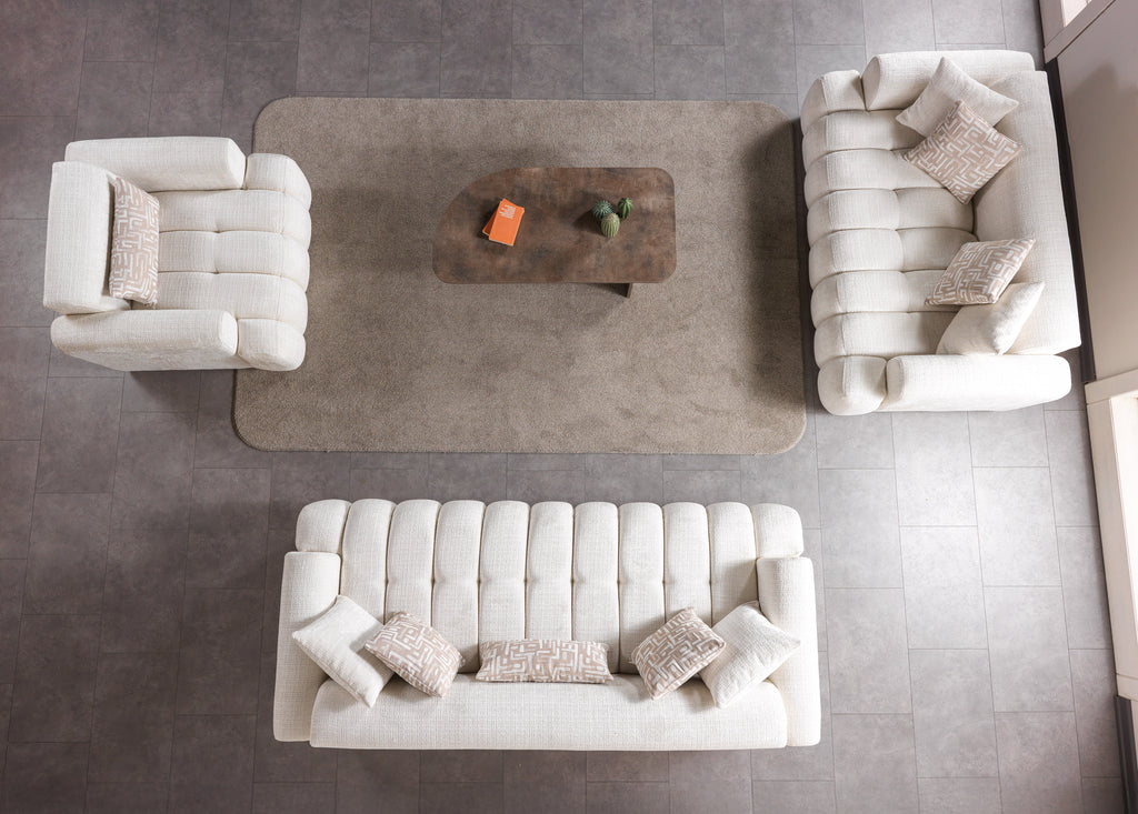 Modern living room with white sofa, armchair, and coffee table on a gray floor.