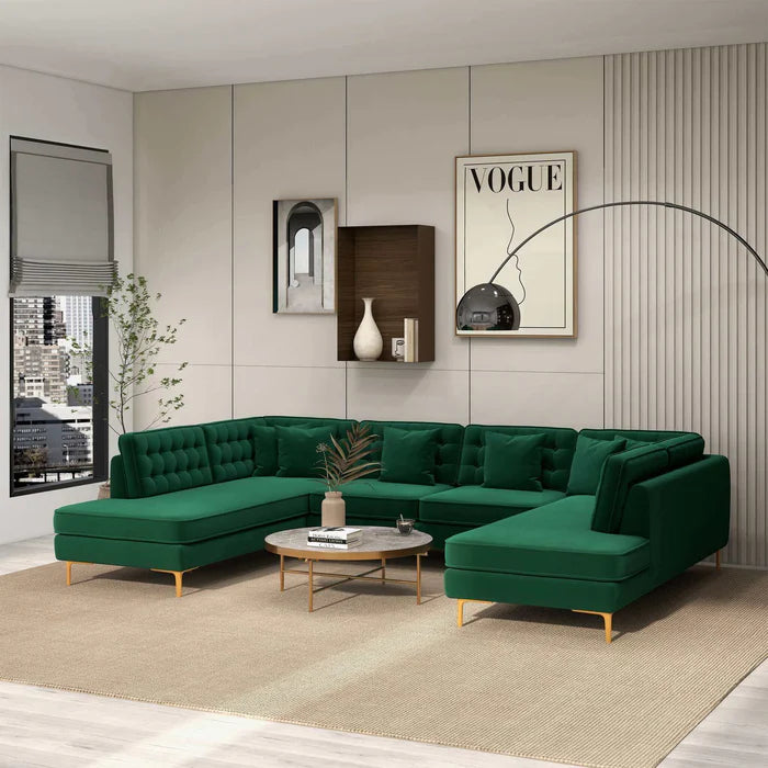 Modern living room with a green sectional sofa, coffee table, and decorative elements.