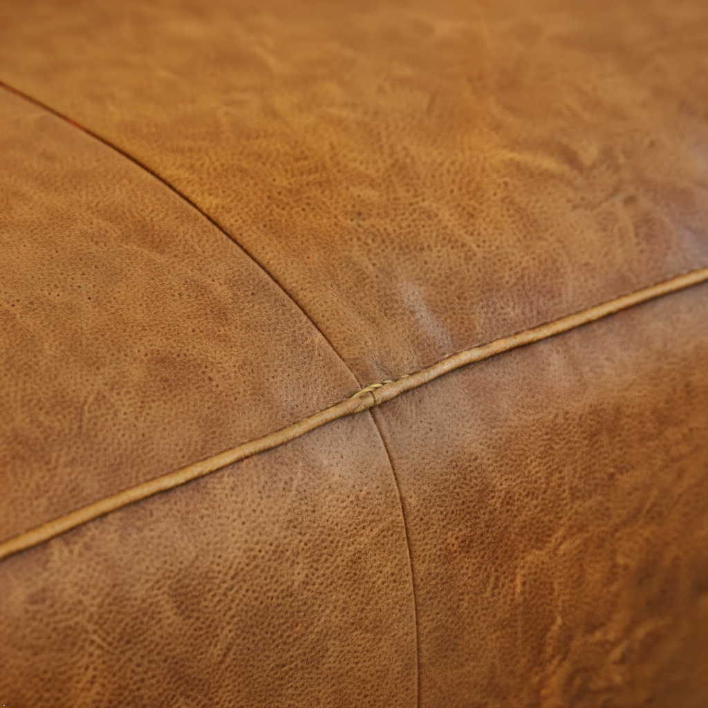 Close-up of brown leather texture with visible stitching