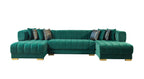 Green sectional sofa with patterned cushions on a white background