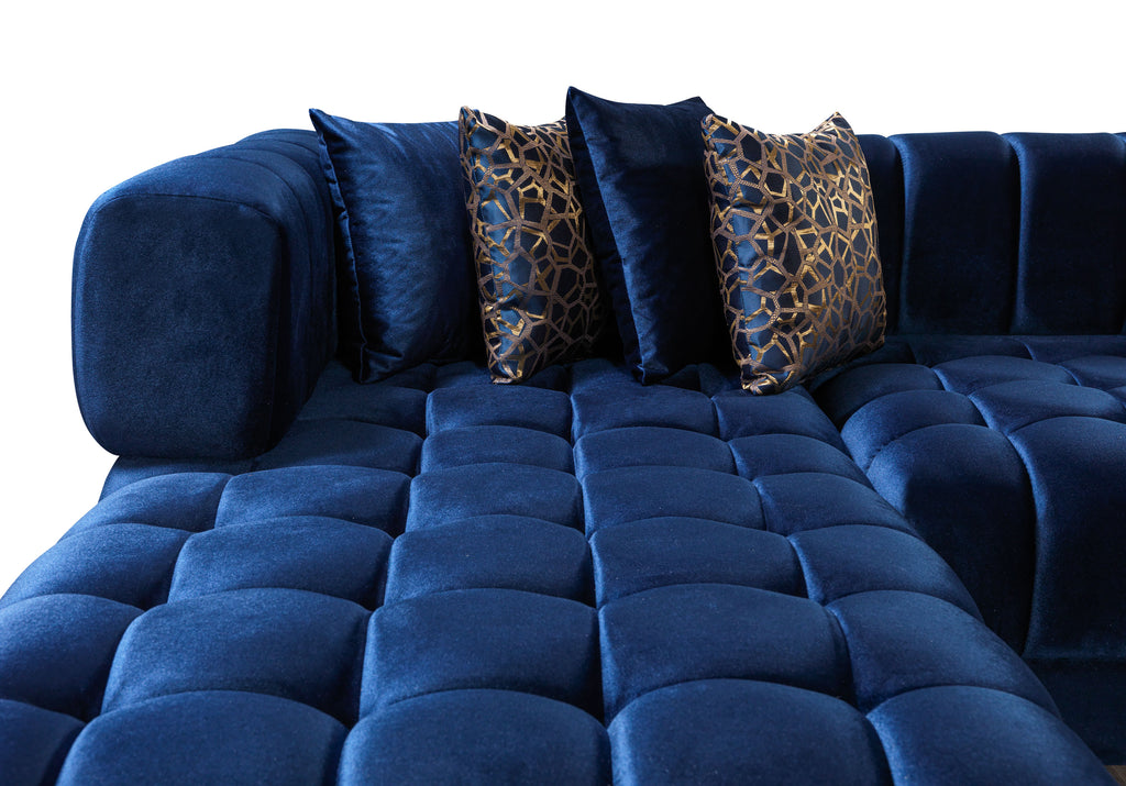 Blue tufted sofa with decorative pillows on a white background