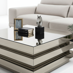 Modern glass coffee table with decorative items in a living room setting